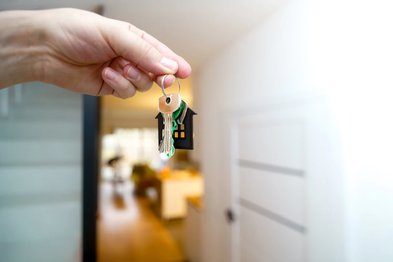 A hand holding the keys to a new home