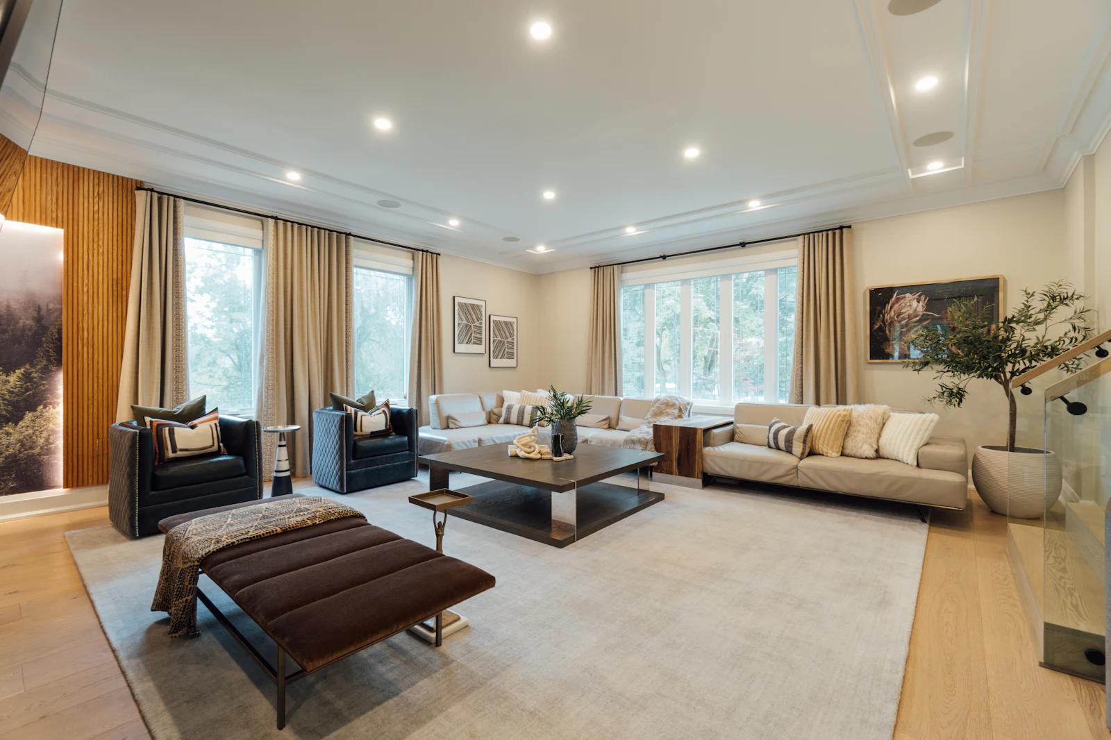 A bright living room with sofas and tall windows