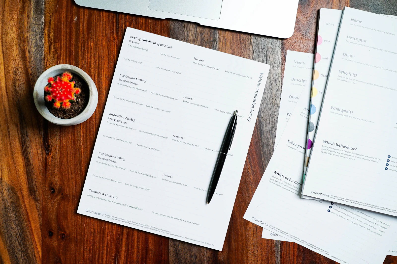 Papers and a pen on a wooden desk